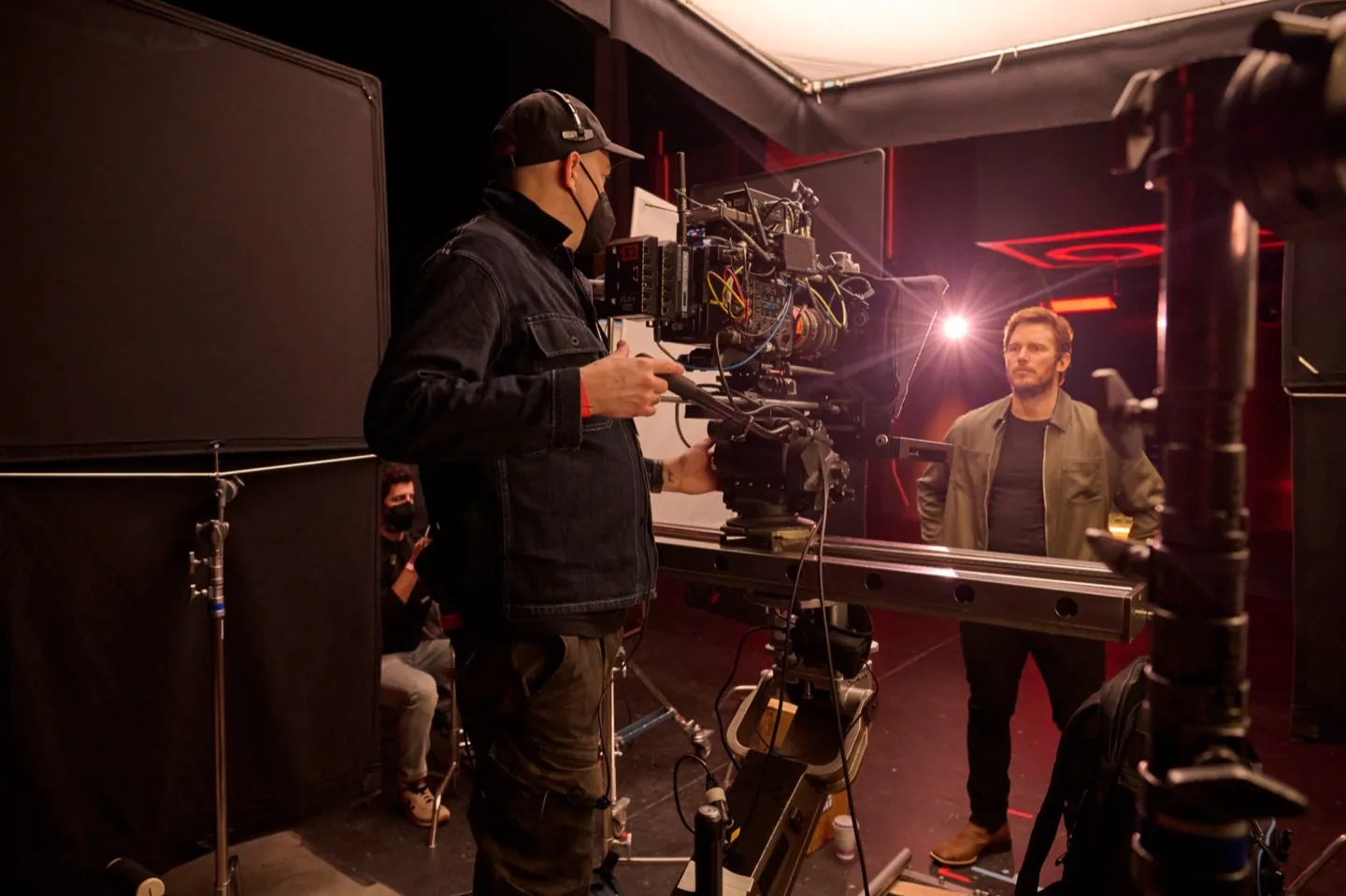 Behind the scenes on a network set — camera crew on a dolly track